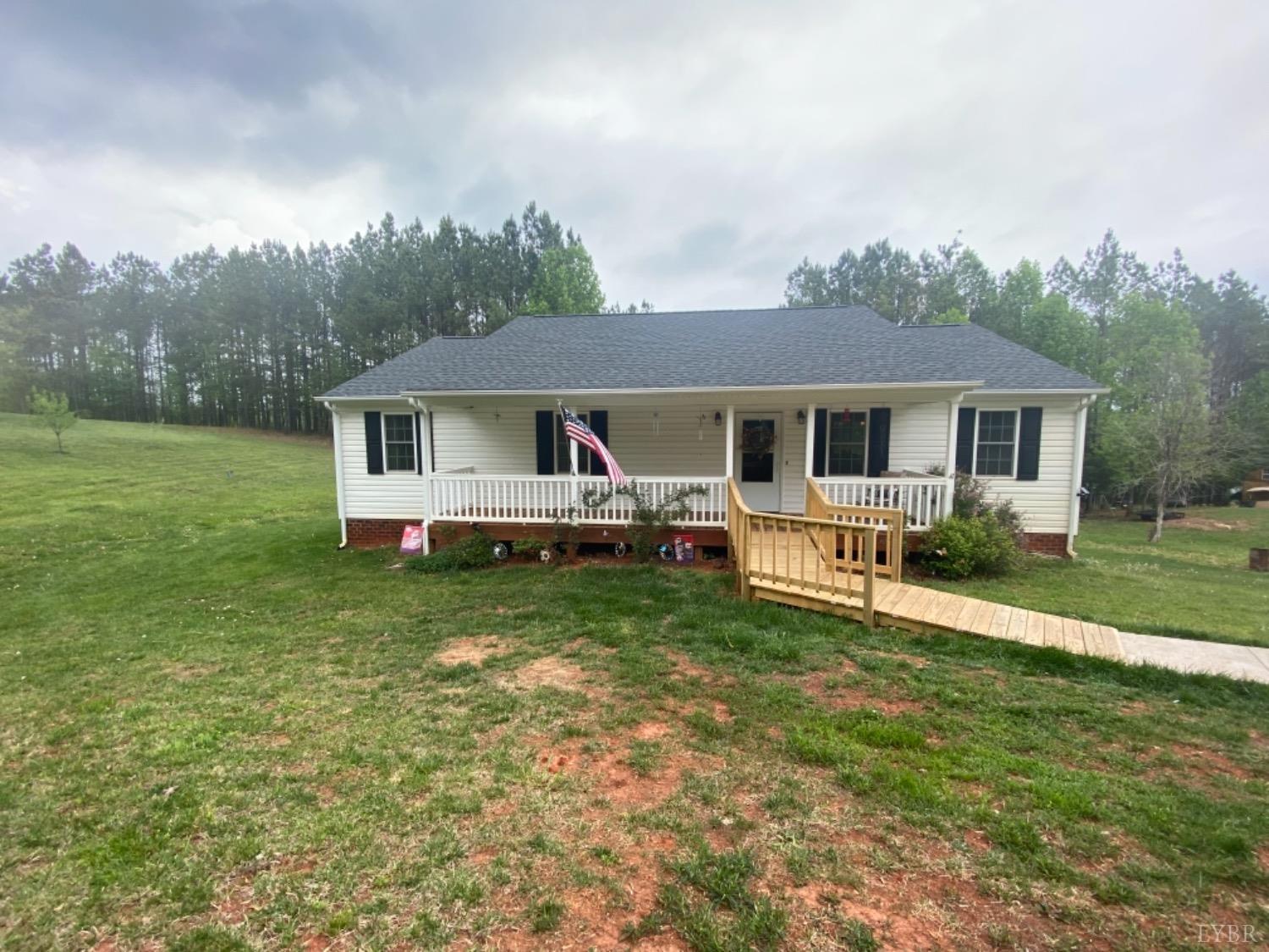 533 Pumping Station Road Spout Spring, VA 24593 - Photo 1 of 19 a front view of a house with a yard table and chairs