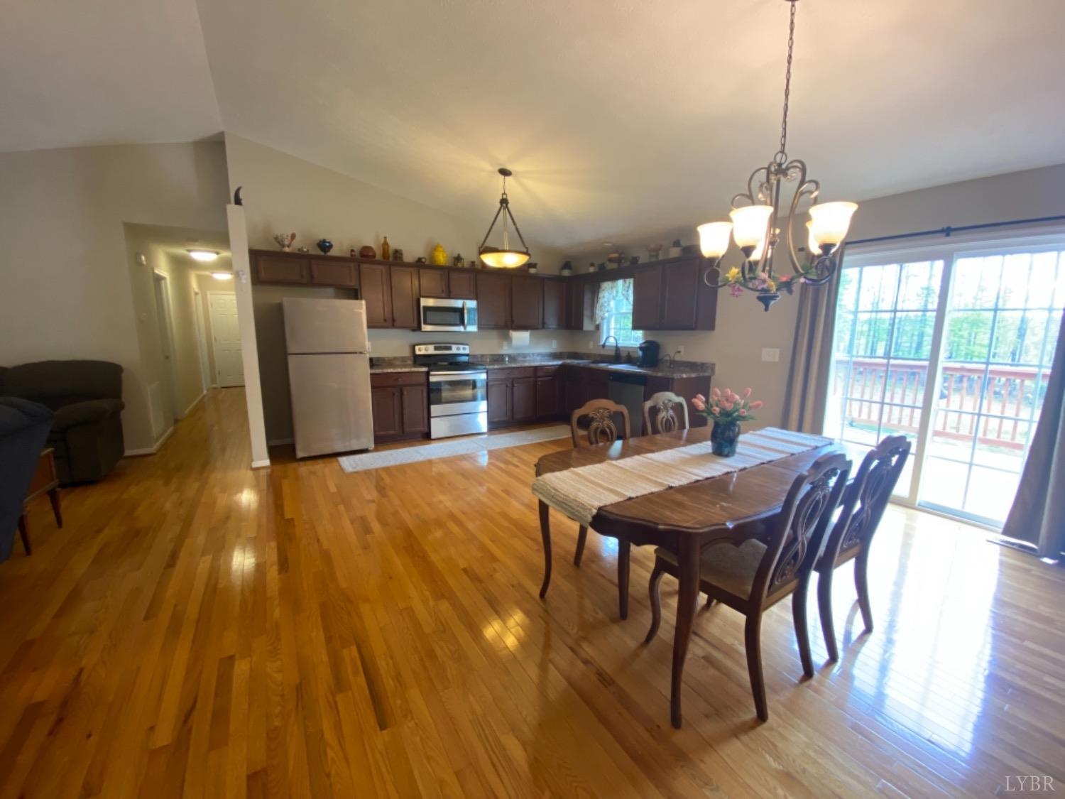 533 Pumping Station Road Spout Spring, VA 24593 - Photo 6 of 19 a view of a dining room with furniture and wooden floor