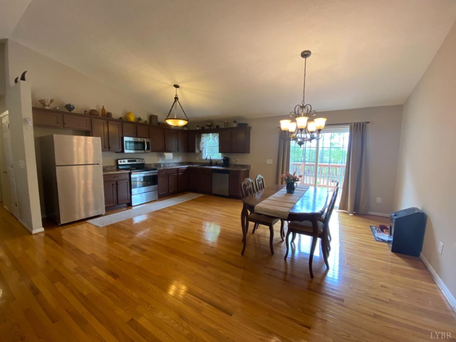 533 Pumping Station Road Spout Spring, VA 24593 - Photo 8 of 19 a view of a dining room with furniture a chandelier and wooden floor