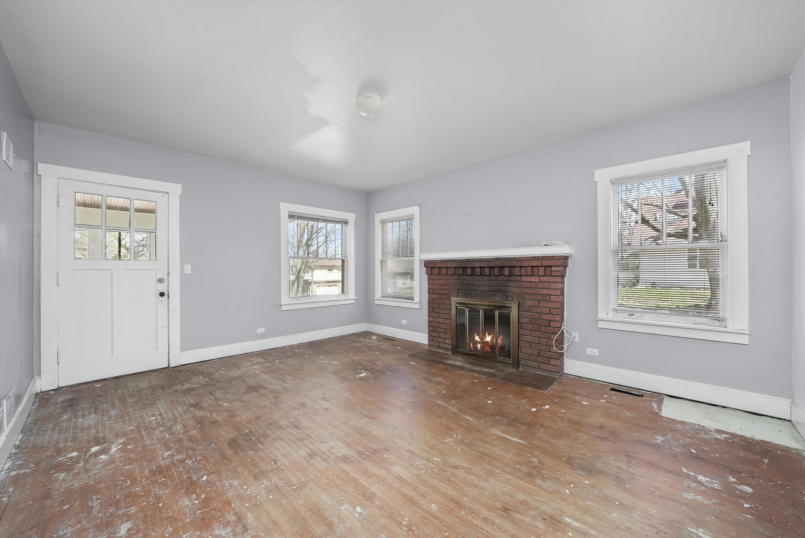 2405 North Club Road McHenry, IL 60051 - Photo 7 of 25 an empty room with windows fireplace and windows