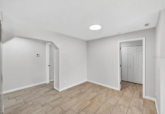 a view of a hallway with white walls and entryway