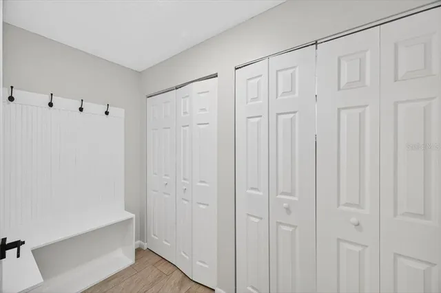 a view of a room with wooden floor and white walls