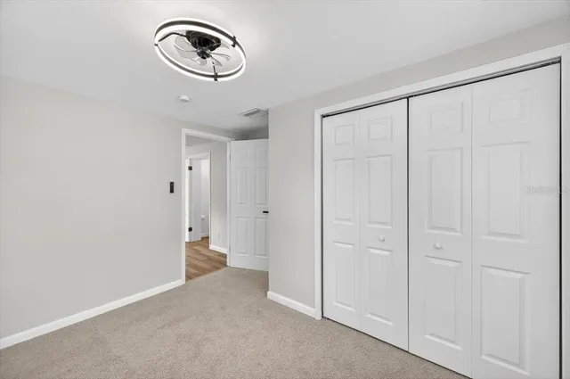 a bathroom with a granite countertop tub sink and mirror