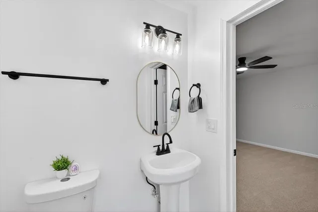 an empty room with a ceiling fan and a window