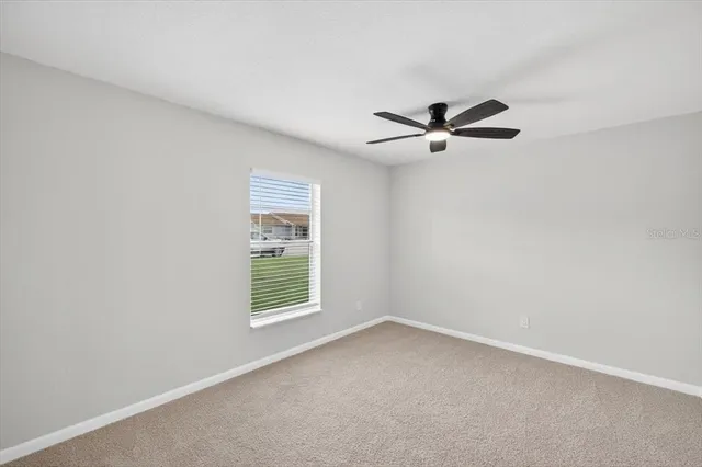 a spacious bathroom with a granite countertop sink and a mirror