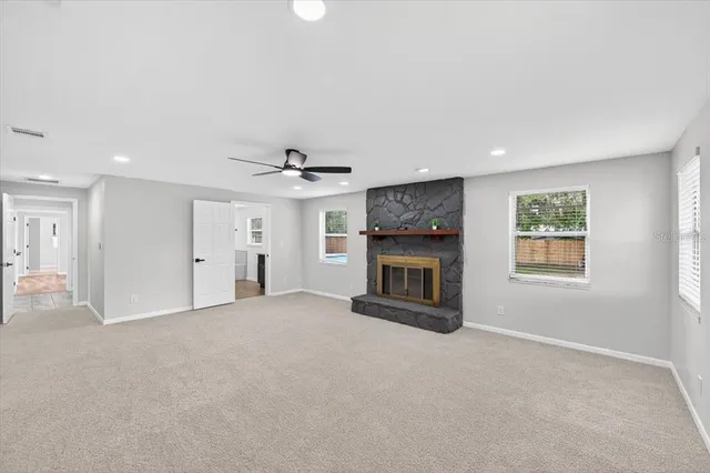 a view of swimming pool with a yard and trees in the background