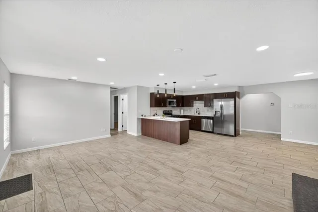a view of empty room with wooden floor and fireplace