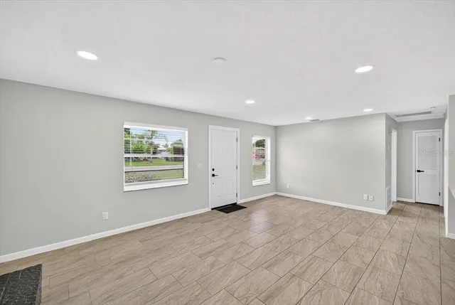 a kitchen with stainless steel appliances a sink a stove top oven a counter space and cabinets