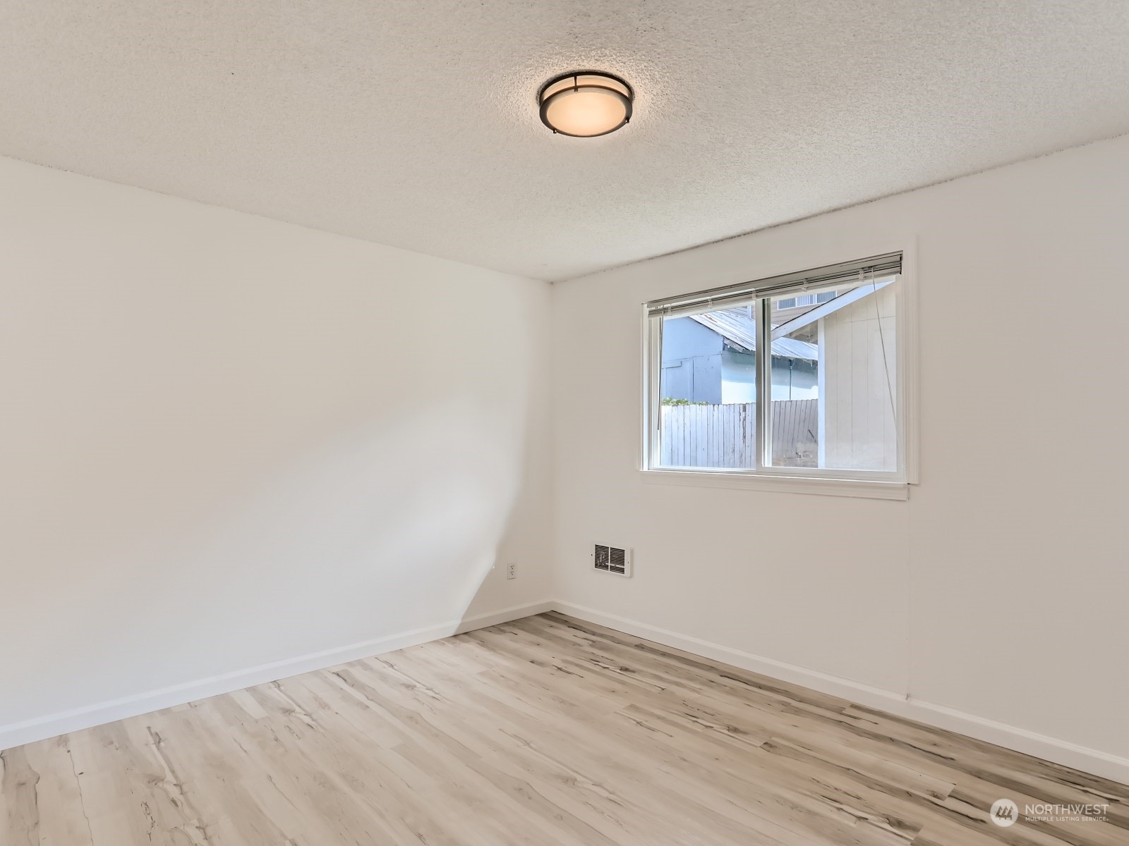 9211 3rd Place Southeast Everett, WA 98208 - Photo 12 of 20 an empty room with a fan and a window