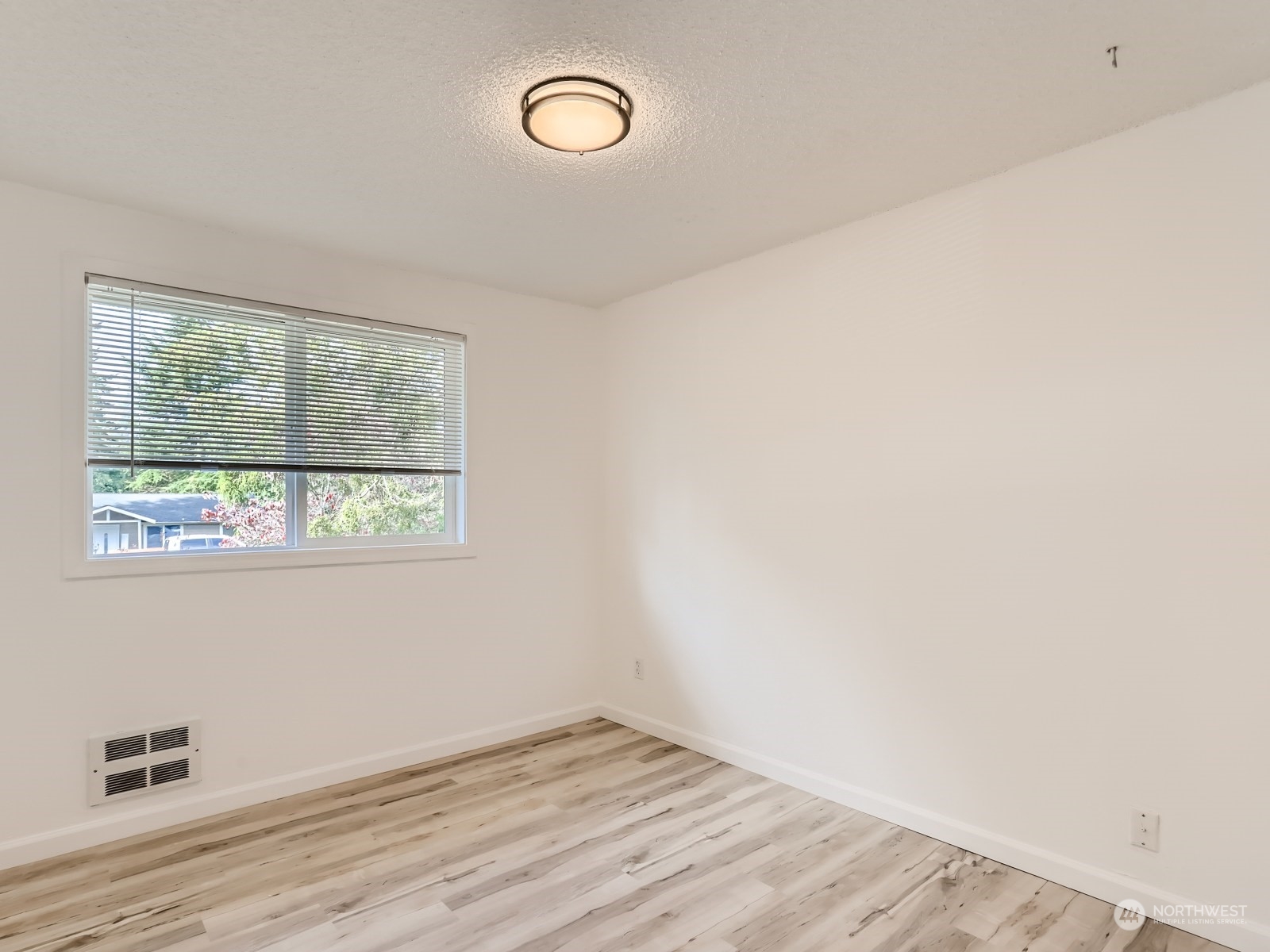 9211 3rd Place Southeast Everett, WA 98208 - Photo 14 of 20 an empty room with wooden floor and windows