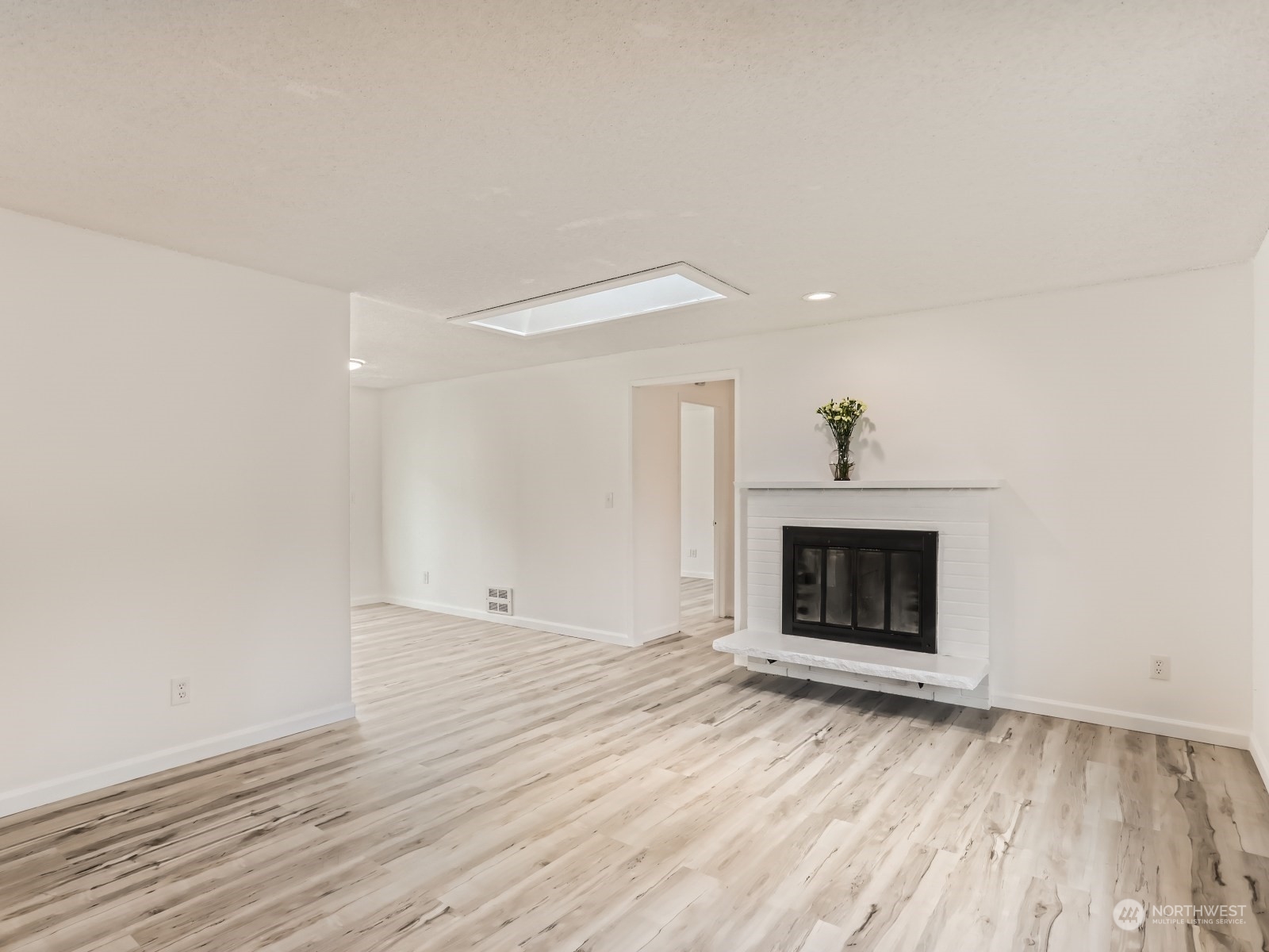 9211 3rd Place Southeast Everett, WA 98208 - Photo 3 of 20 a view of an empty room with wooden floor fireplace and a window