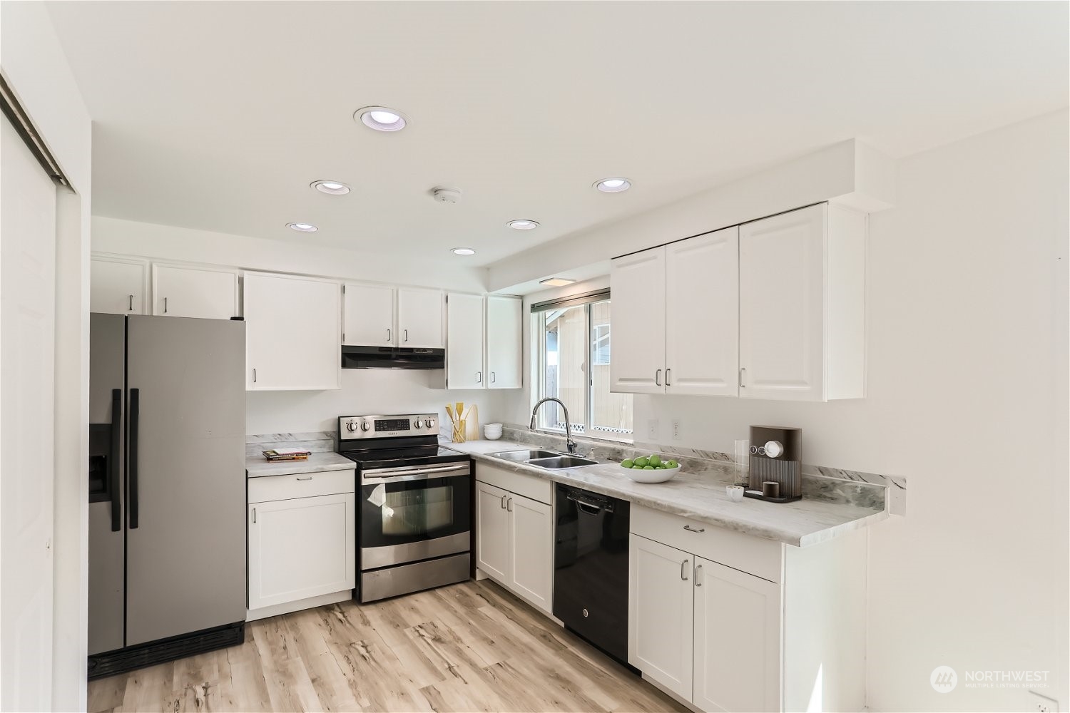 9211 3rd Place Southeast Everett, WA 98208 - Photo 4 of 20 a kitchen with stainless steel appliances granite countertop white cabinets a sink a stove a refrigerator and white cabinets