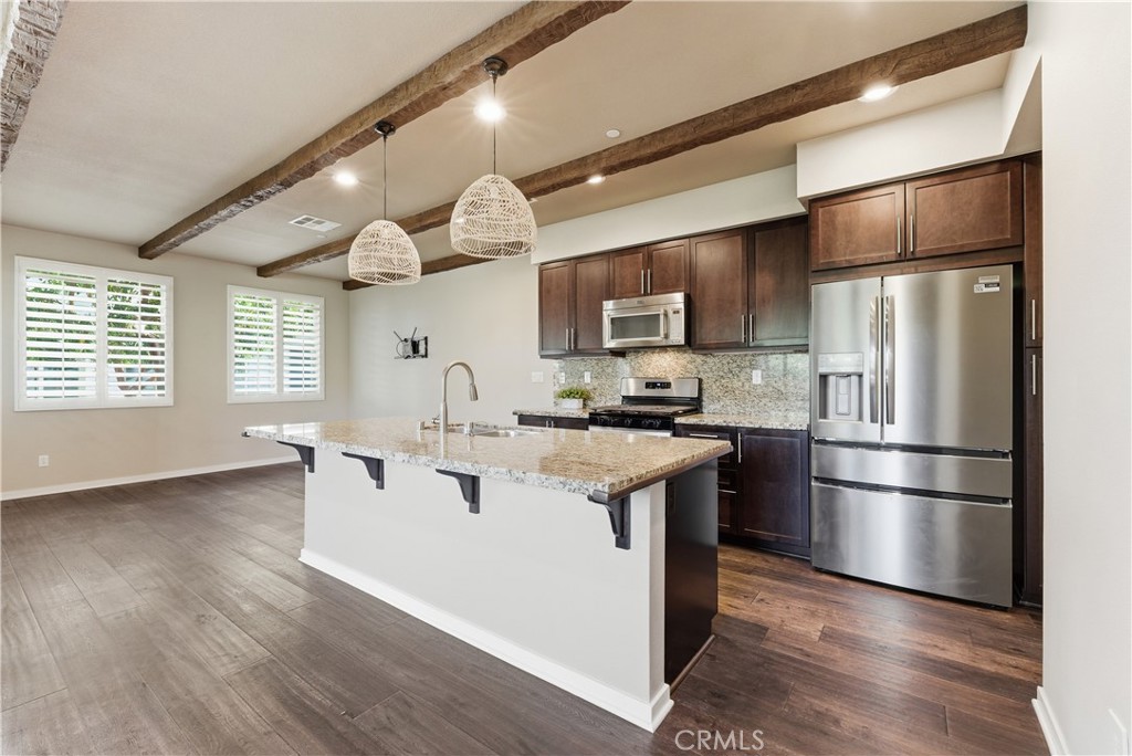 77 Adelfa Street Rancho Mission Viejo, CA 92694 - Photo 11 of 64 Beautiful open kitchen with granite,New refrigerator, new oven/range and shutters!