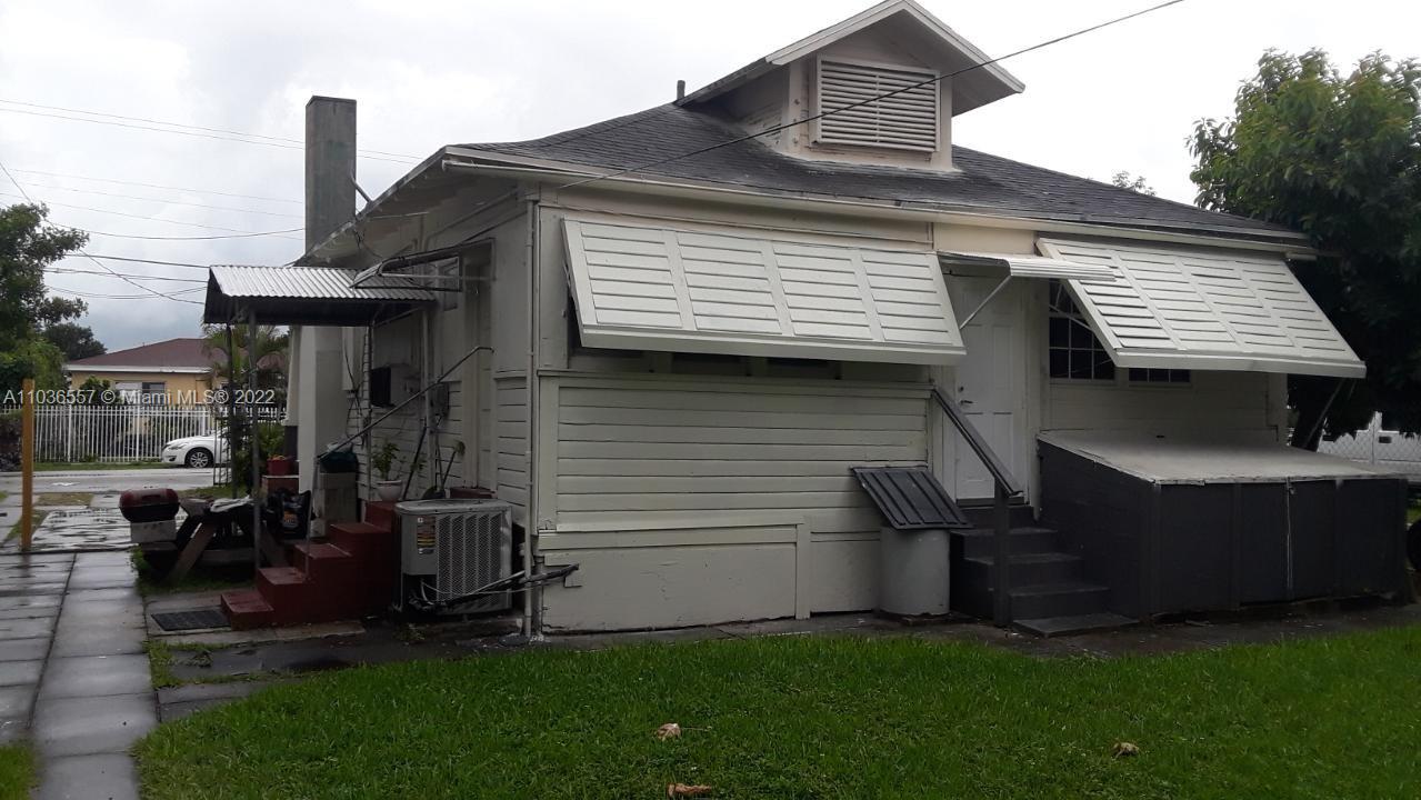 1759 Northwest 18th Terrace Miami, FL 33125 - Photo 4 of 10 a front view of a house with a garden