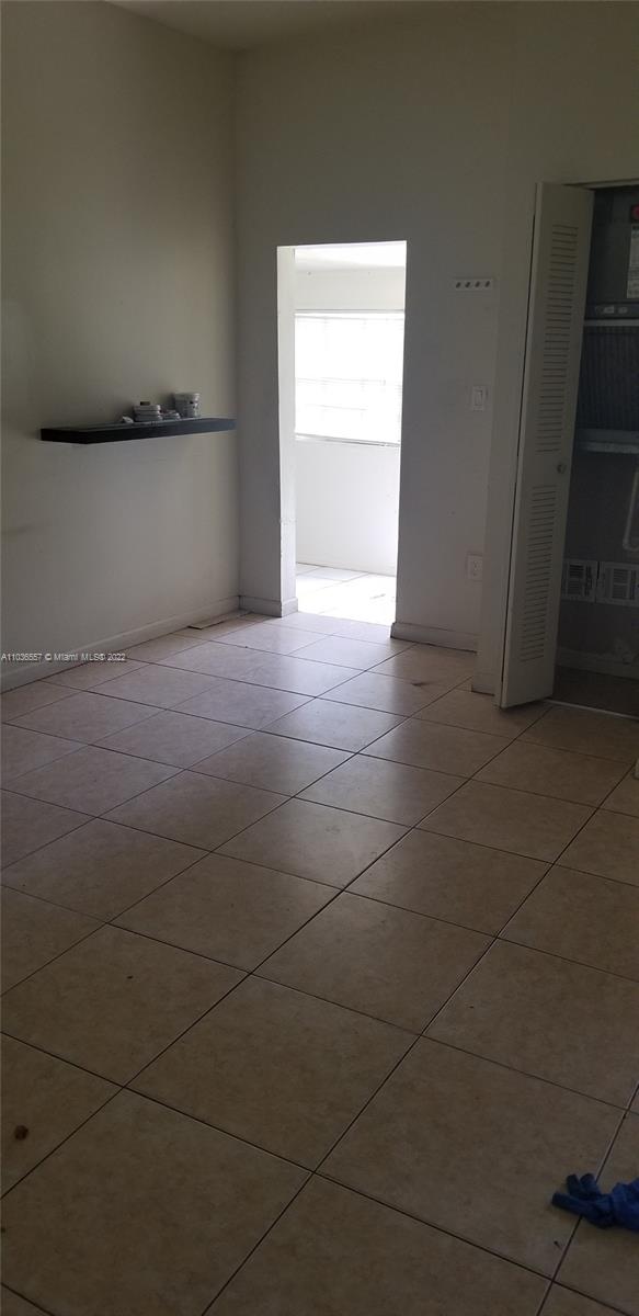 1759 Northwest 18th Terrace Miami, FL 33125 - Photo 6 of 10 a view of an empty room and a window
