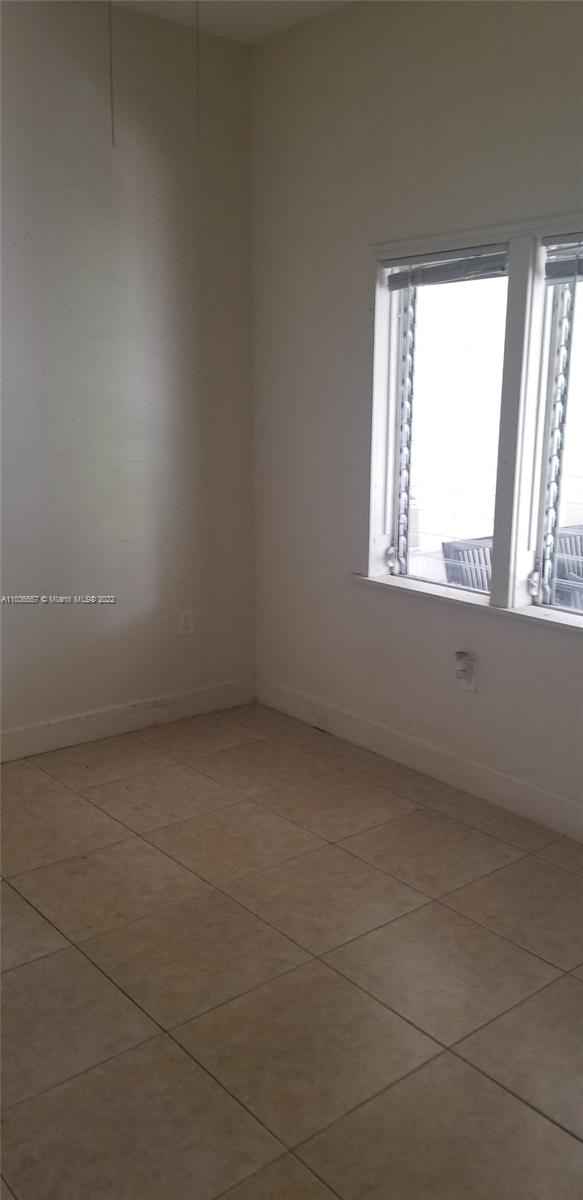 1759 Northwest 18th Terrace Miami, FL 33125 - Photo 8 of 10 an empty room with a window