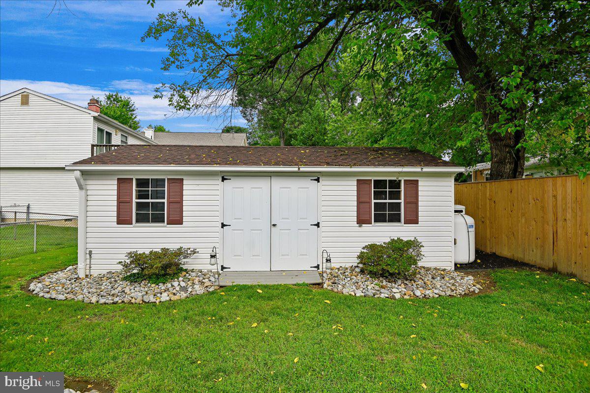 1731 Tacoma Road Edgewater, MD 21037 - Photo 11 of 59 Charming garden shed with lush greenery.