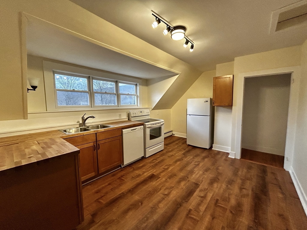 46 Elm Street, Unit 2 Buckland, MA 01370 - Photo 3 of 15 a view of a kitchen with a sink and dishwasher with wooden floor