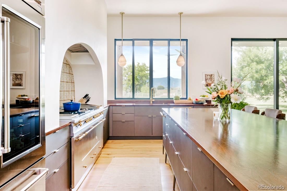 6122 Monarch Road Longmont, CO 80503 - Photo 11 of 40 a large kitchen with kitchen island granite countertop a large window