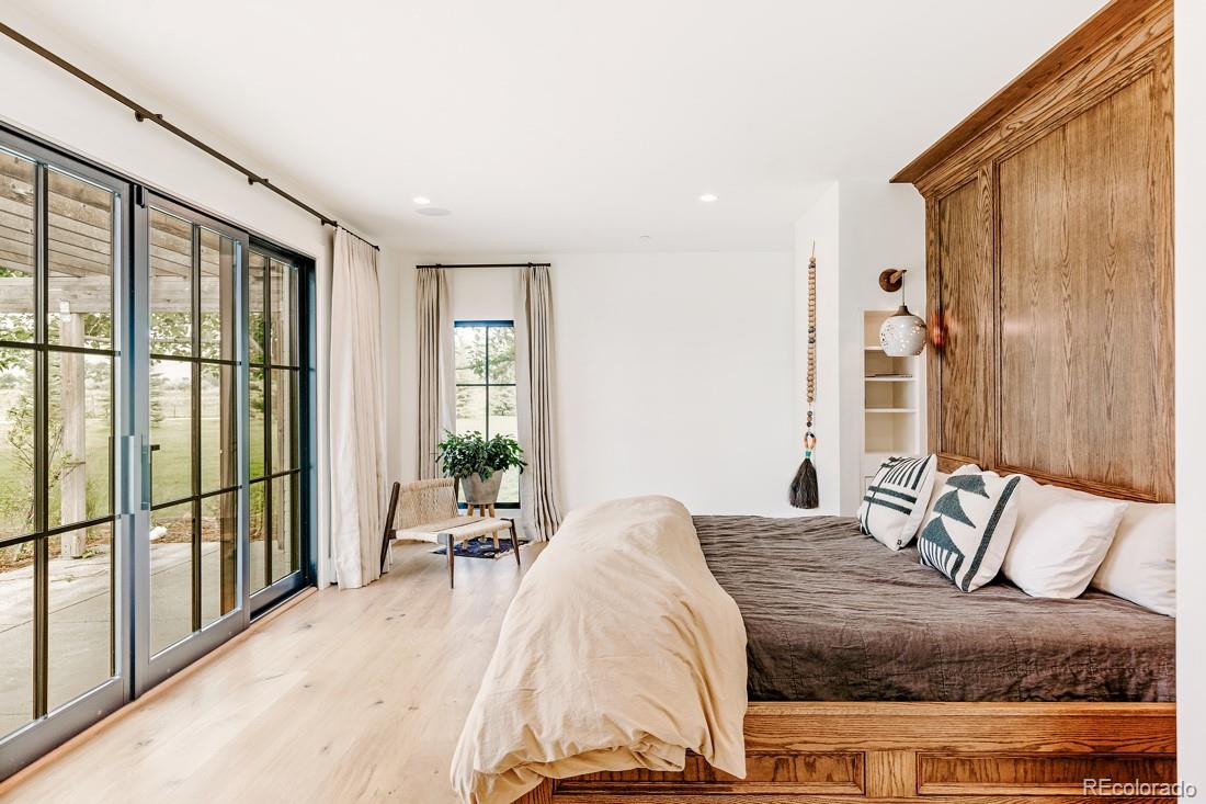 6122 Monarch Road Longmont, CO 80503 - Photo 17 of 40 a bedroom with a large bed and a large window