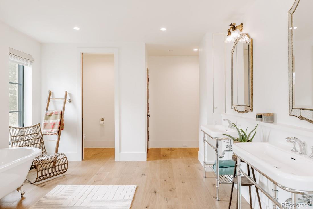 6122 Monarch Road Longmont, CO 80503 - Photo 21 of 40 a bathroom with a tub sink and mirror
