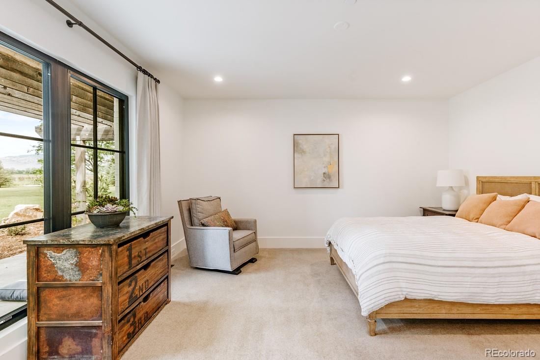 6122 Monarch Road Longmont, CO 80503 - Photo 22 of 40 a bedroom with a bed and a couch