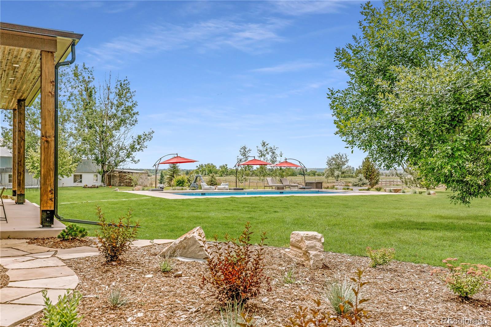 6122 Monarch Road Longmont, CO 80503 - Photo 33 of 40 a garden with trees in the background