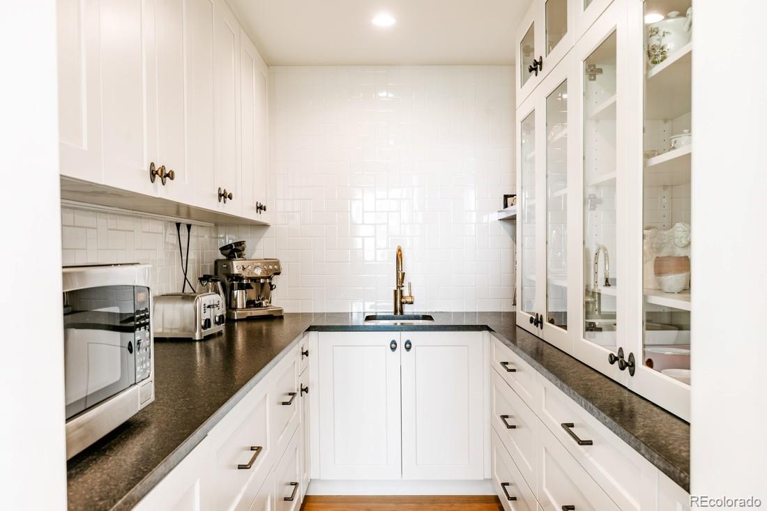 6122 Monarch Road Longmont, CO 80503 - Photo 36 of 40 a kitchen with granite countertop a sink and stainless steel appliances