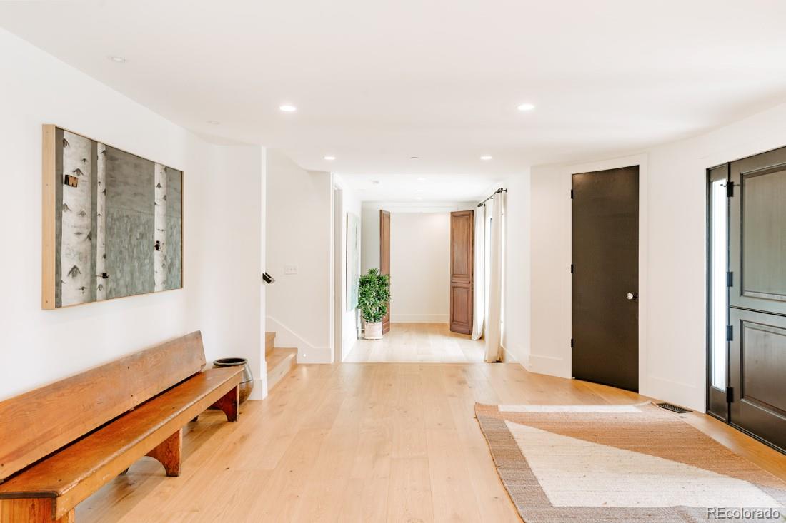 6122 Monarch Road Longmont, CO 80503 - Photo 6 of 40 a spacious bedroom with a large bed and a chandelier