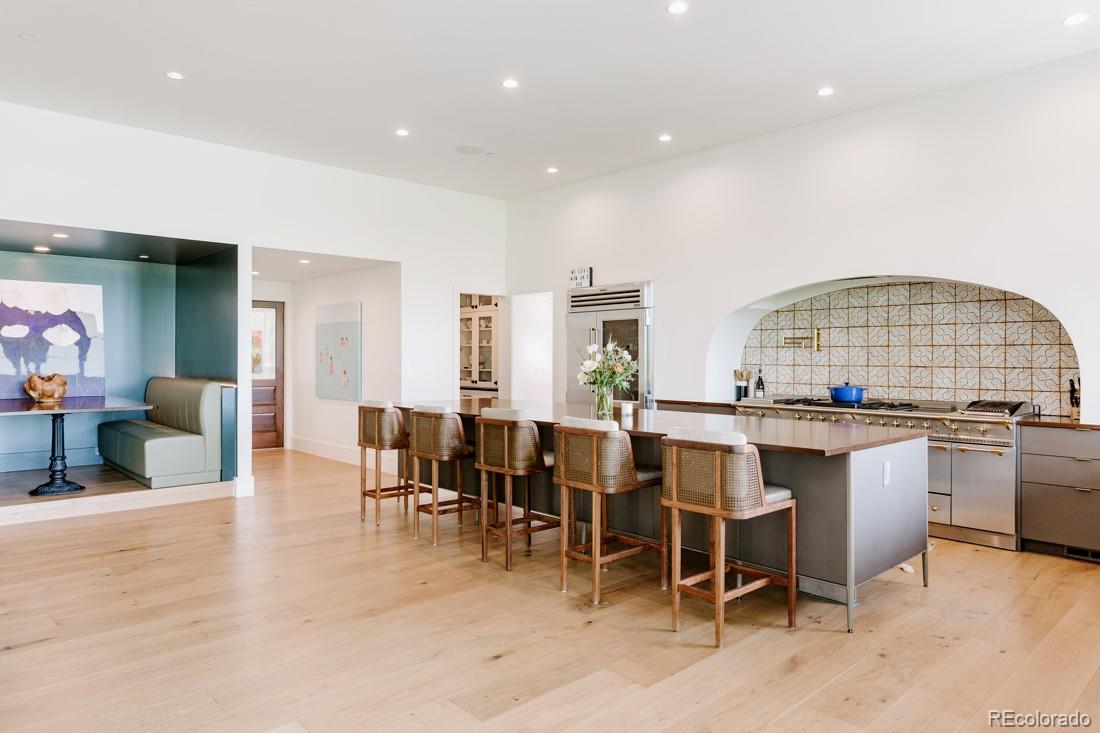 6122 Monarch Road Longmont, CO 80503 - Photo 8 of 40 a open kitchen with stainless steel appliances granite countertop a table and chairs in it
