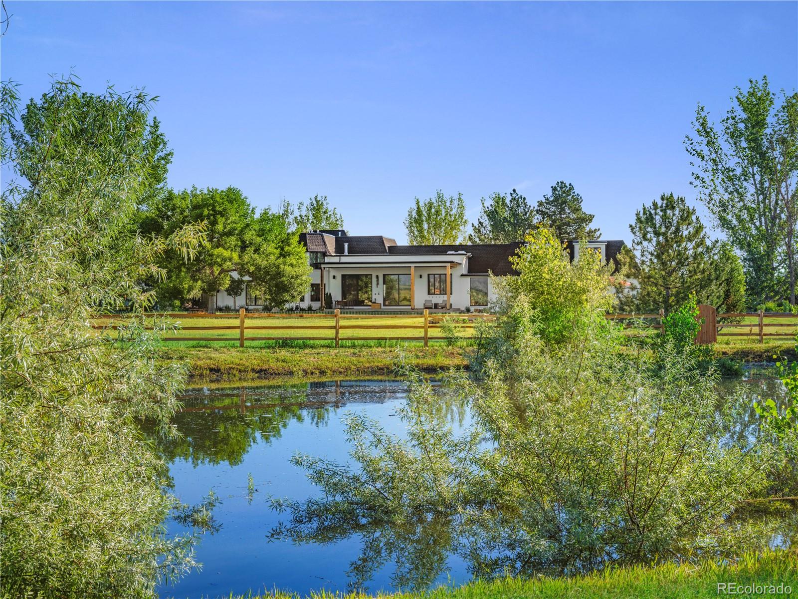 6122 Monarch Road Longmont, CO 80503 - Photo 9 of 40 a view of a lake with a house in the background
