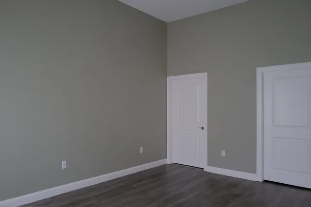 an empty room with wooden floor
