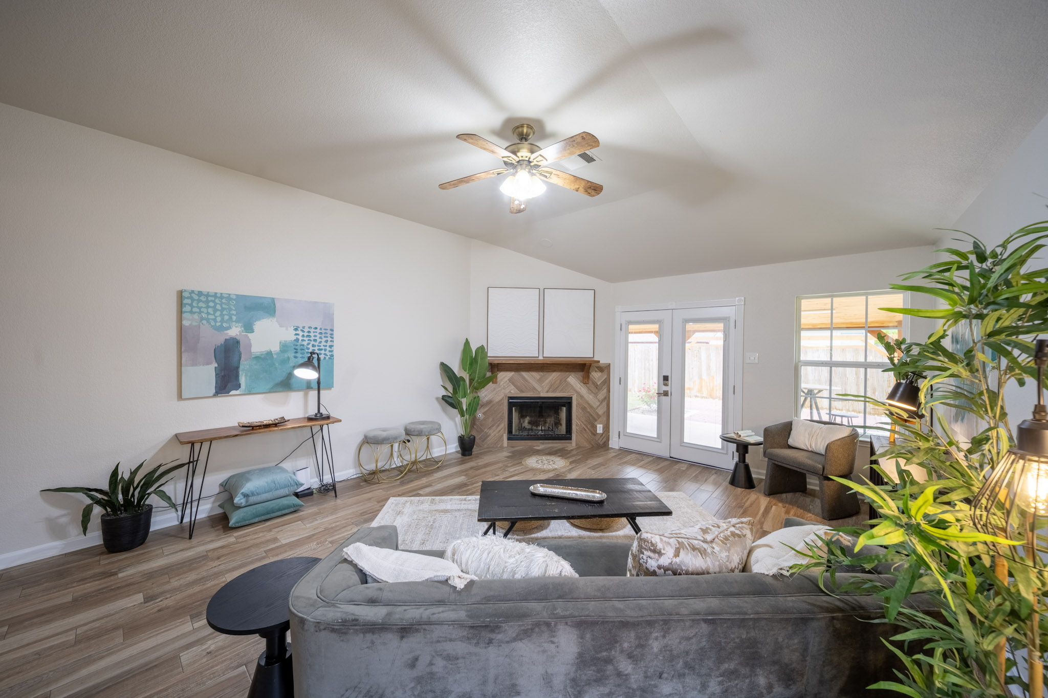 1302 Newbury Street Georgetown, TX 78626 - Photo 11 of 20 a living room with furniture a fireplace and a chandelier