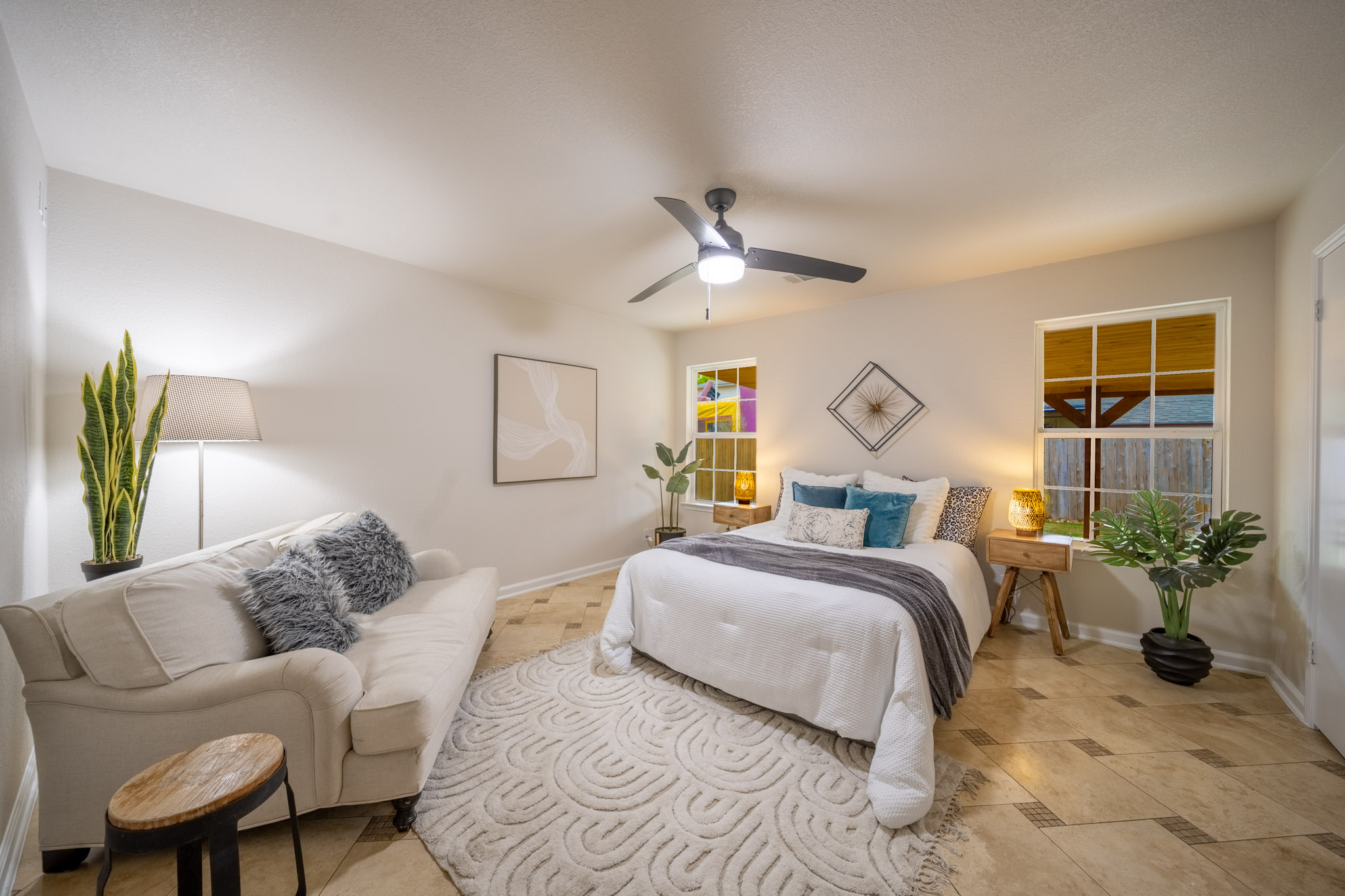 1302 Newbury Street Georgetown, TX 78626 - Photo 13 of 20 a bedroom with a bed couches and potted plant