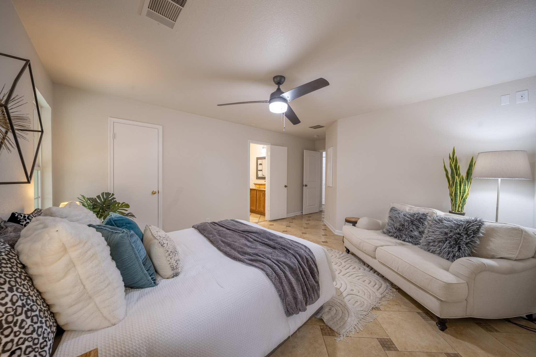 1302 Newbury Street Georgetown, TX 78626 - Photo 14 of 20 a bedroom with a bed couch and a ceiling fan