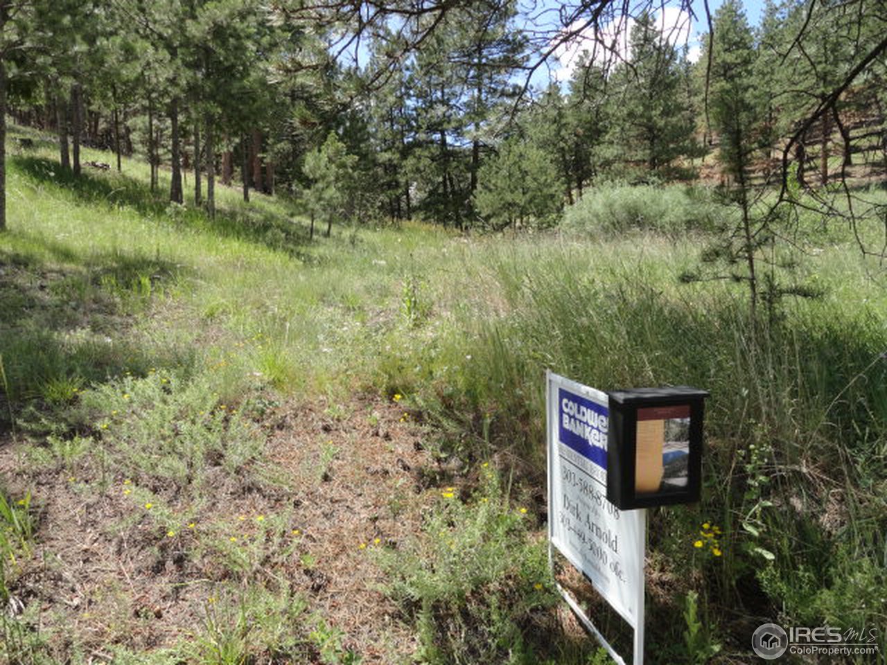 375 Arroyo Chico Boulder, CO 80302 - Photo 3 of 15 a view of a wooden fence next to a lake