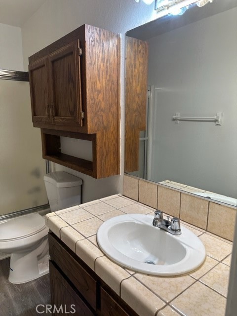 14952 Ritter Street, Unit C Victorville, CA 92394 - Photo 7 of 8 a bathroom with a sink toilet and vanity