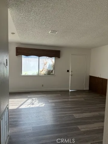 a view of wooden floor and cabinet in a room