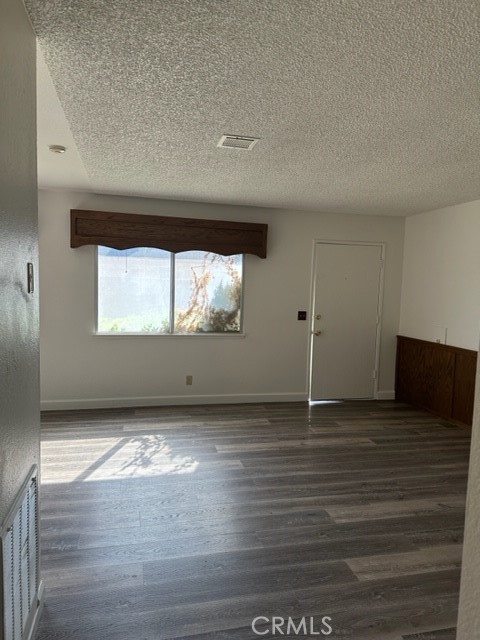 14952 Ritter Street, Unit C Victorville, CA 92394 - Photo 8 of 8 a view of wooden floor and cabinet in a room