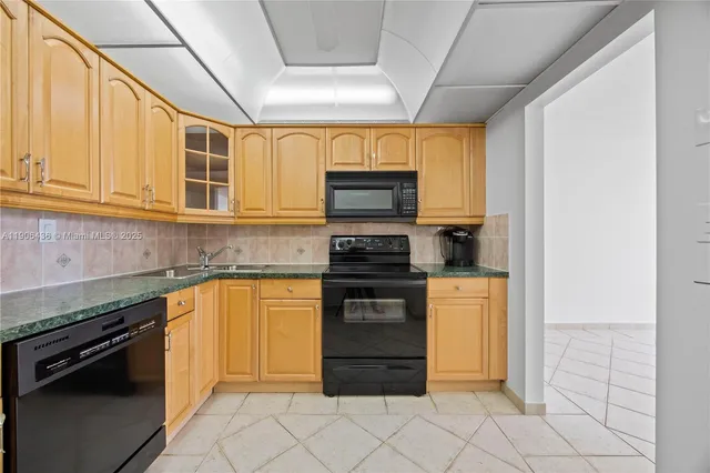 a kitchen with stainless steel appliances granite countertop a stove and a refrigerator