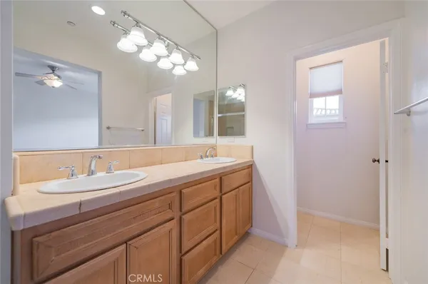 a bathroom with a double vanity sink and a mirror