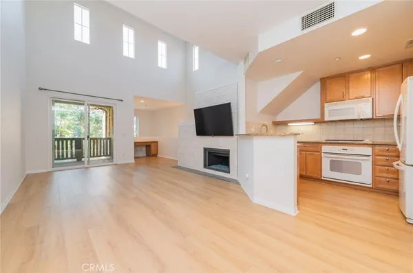 a view of a kitchen with a sink a stove top oven and kitchen island