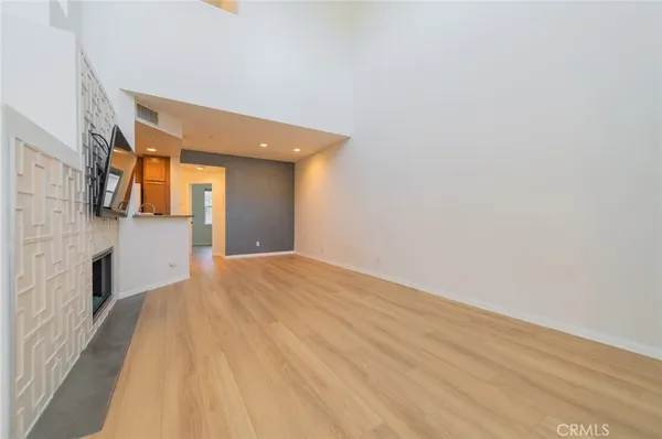 a view of a big room with wooden floor and brick walls