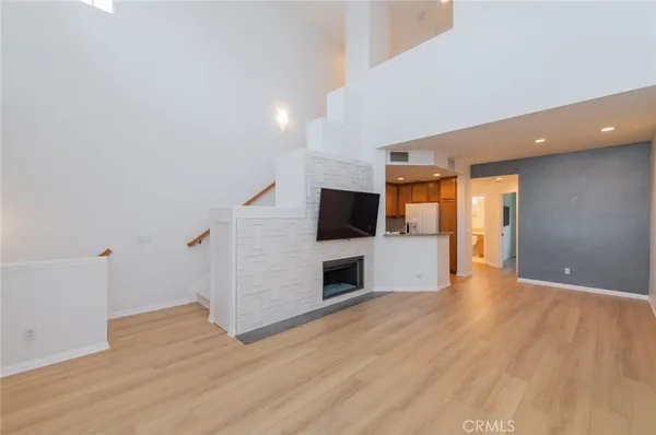 a view of a livingroom with an empty space and a fireplace