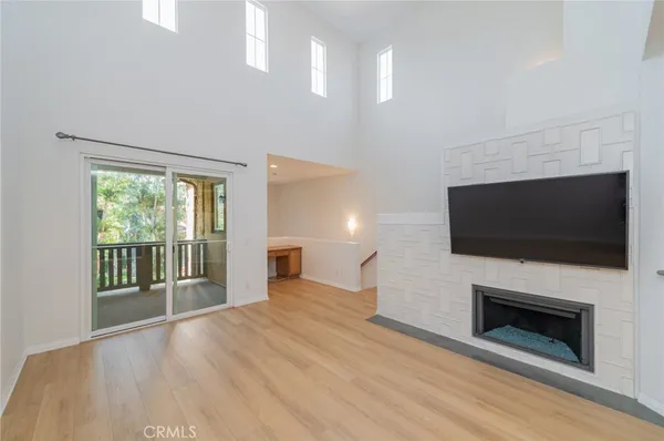 a view of a livingroom with an empty space and a fireplace