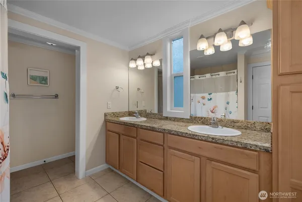 a bathroom with a granite countertop sink a mirror and a shower