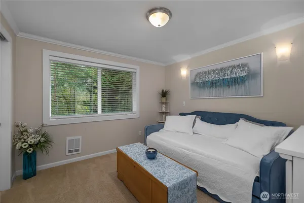 a bedroom with a bed and a potted plant