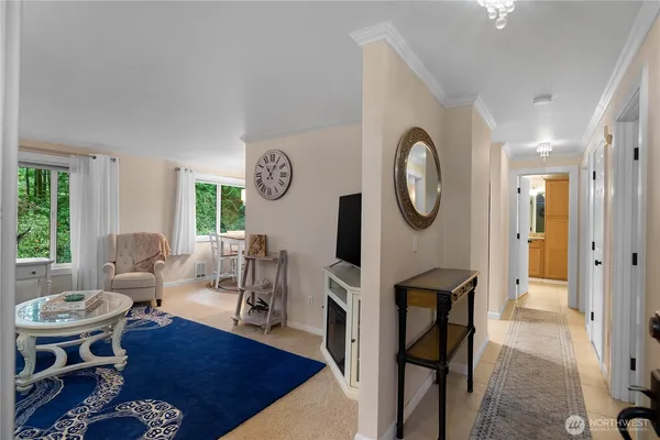 a living room with furniture a rug a clock and a window