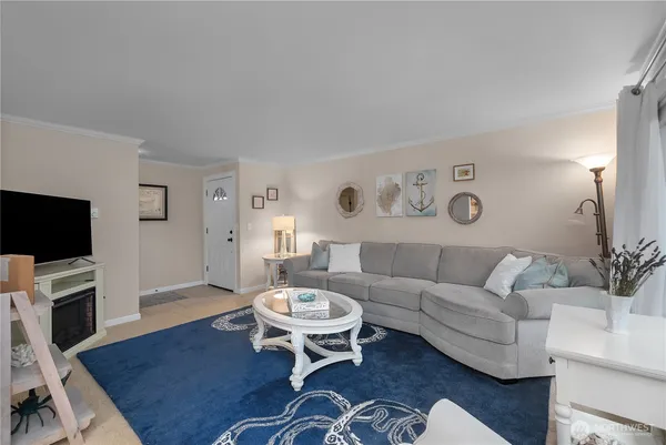 a living room with furniture a flat screen tv and a dining table