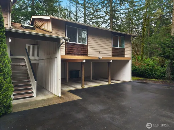 a view of backyard with barbeque oven and trees